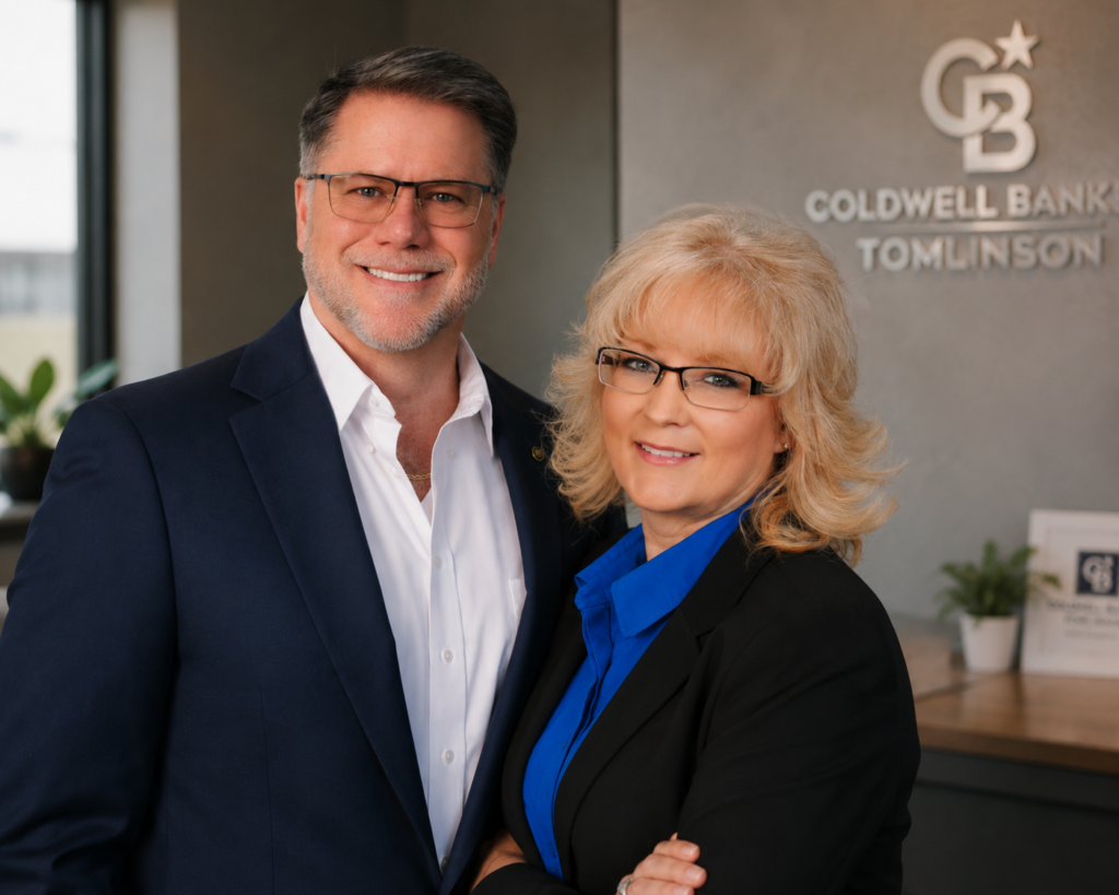 Two smiling real estate agents in office